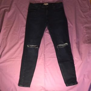 Knee ripped blue skinny jeans